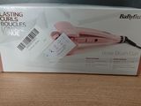 packaging of a babylis hair dryer sitting on a wooden table