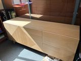 a wooden cabinet with a mirror on top of it