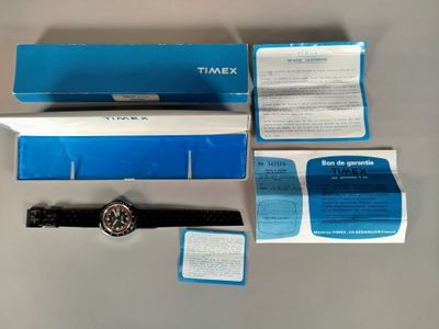a watch that is sitting on a table next to a box