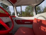 a red and white interior of a car with a steering wheel