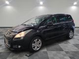a black minivan is parked on a checkered tile floor