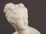 statue of a woman with a flower in her hair