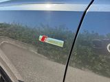a close up of a car ' s door handle with a sticker on it
