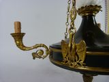 a chandelier with a candle and a bird on it