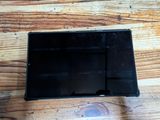 a small black object on a wooden table