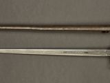 an old knife and a small knife on a metal surface