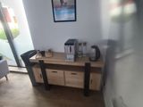 a picture of a room with a coffee maker on the table