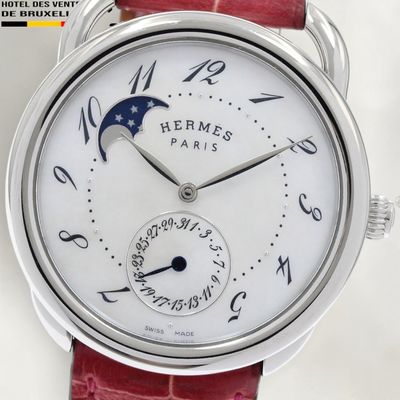 a close up of a wrist watch with a moon on it