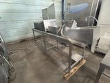 a large metal sink in a room with a lot of counter space