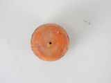 an orange candle that is sitting on a white table