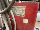 an image of a red machine with wires attached to it