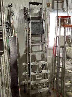 many ladders that are in a room with a window