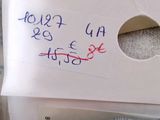 a piece of paper with writing on it sitting on top of a pile of clothes