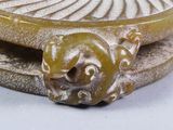 a close up of a sculpture of a lion on a plate