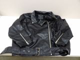 black leather jacket with zippers and zippered cuffs on a shelf