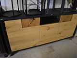 a black and wood cabinet with two black lamps on top of it