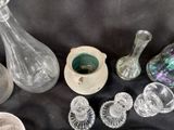 many glass vases and other glass items on a table