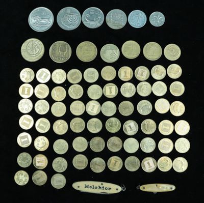 some of the coins are in a display case on a black surface