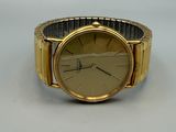 an image of a gold watch on a white surface