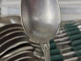many spoons and bowls stacked together in the kitchen