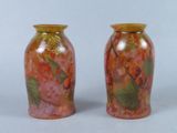 two vases sitting side by side on a white surface