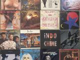 many different album covers on the wall of this room