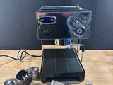 a close up of a coffee machine on a wooden table