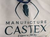 a white bag with a blue ribbon on it that says manufacture casteex