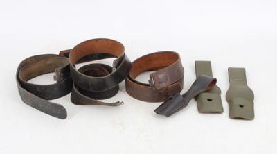 a lot of different types of belts on a white surface