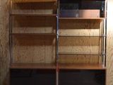 a wooden shelf with a glass door in the corner