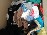 a box full of clothes that is sitting on the floor