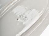 a white plate with a handle on it on a table