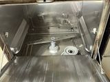 a silver oven with a door open in a kitchen