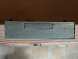 a close up of a piece of wood with a metal handle