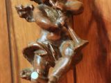 a statue of a little girl sitting on a swing