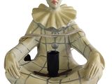 a figurine of a woman sitting on the ground with a cup in her hand