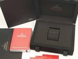 a black box with a watch and a red card in it