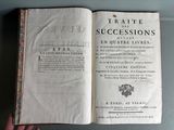 someone is holding a book open on a table that has a title on it