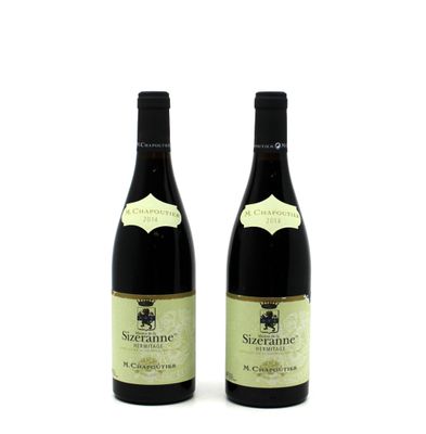 two bottles of wine sitting next to each other on a white surface
