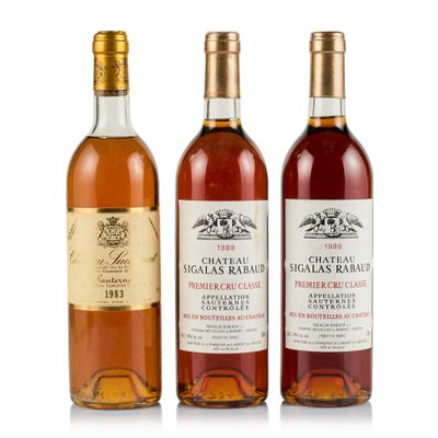 three bottles of wine sitting next to each other on a white surface
