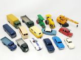 a lot of toy cars and trucks on a white surface