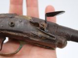 a hand holding a gun that is in the palm of someone ' s hand