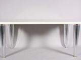 an image of a white table with clear legs and a white top