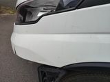 a close up of a white truck parked on the side of the road