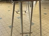 a person sitting at a table with a laptop on top of it