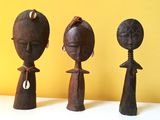 three wooden figurines that are sitting on a table