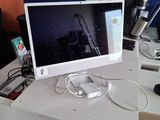 a computer monitor sitting on a desk in an office