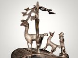 an image of a statue of a group of animals on a rock