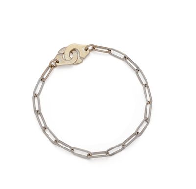 a close up of a chain bracelet with a key on a white background