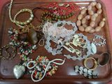 a tray with many different types of jewelry on it